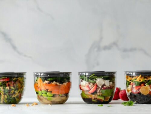 four clear plastic bowls with vegetables